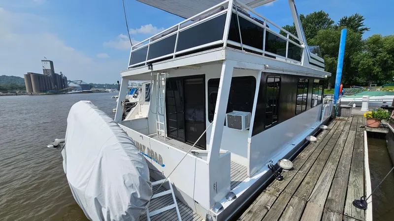 Slide: The Image of 1993 Skipperliner 47 SL houseboat docked on a river with industrial background. - 4
