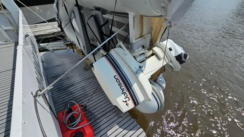 Slide: The Image of Outboard motor on 1993 Skipperliner 47 SL boat docked by water. - 40