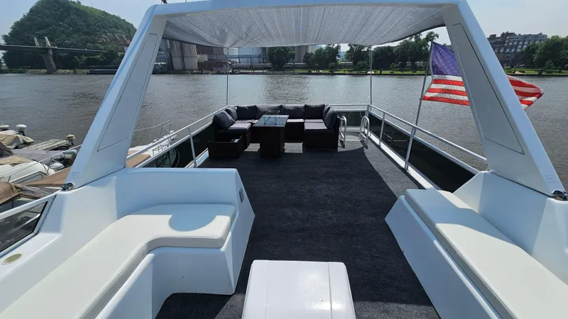 Slide: The Image of 1993 Skipperliner 47 SL boat deck with seating, American flag, and river view. - 7