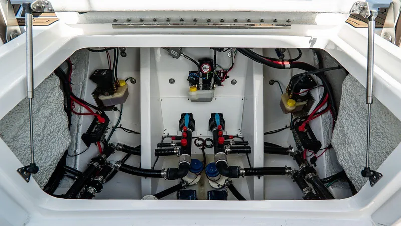 Slide: The Image of Engine compartment of 2026 Tidewater 3100 Carolina Bay boat, showcasing wiring and components. - 3
