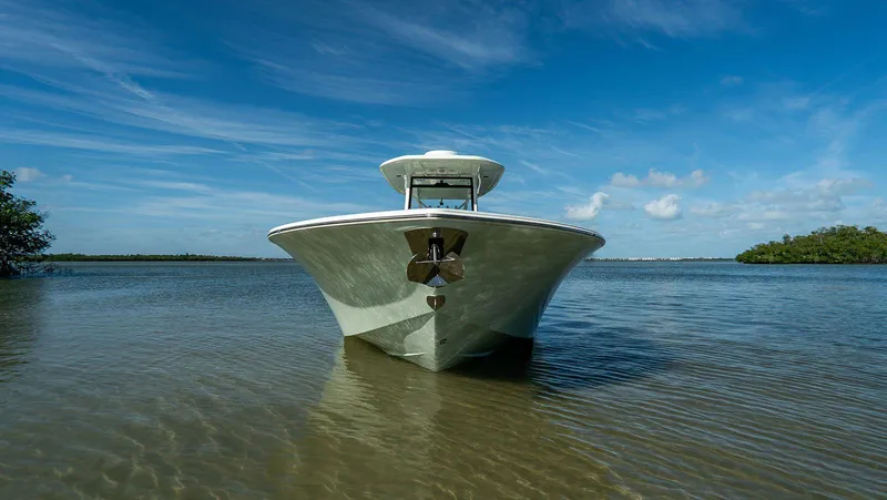Slide: The Image of 2026 Tidewater 3100 Carolina Bay boat on calm water under clear blue sky. - 4