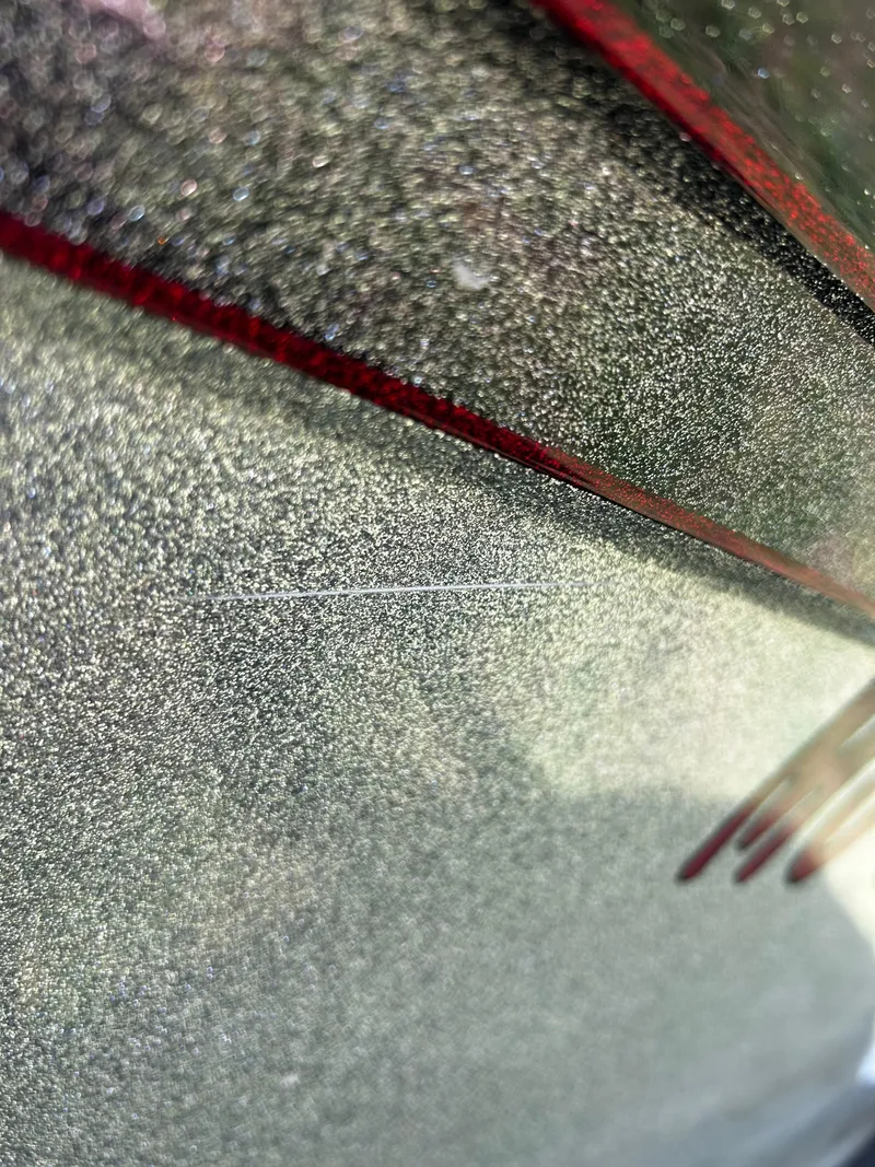 Slide: The Image of Close-up of 2023 Ranger Z521R Ranger Cup Equipped boat with metallic finish and red accents. - 10