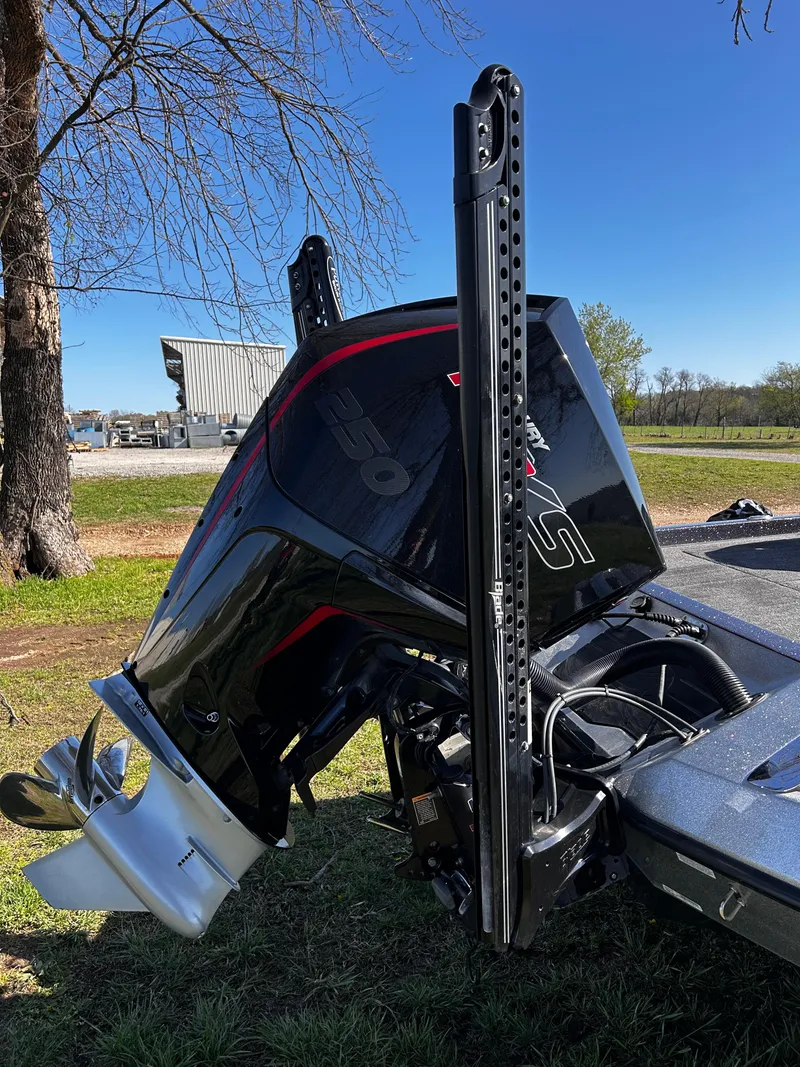 Slide: The Image of 2023 Ranger Z521R boat engine, black and silver, parked outdoors on grass. - 11