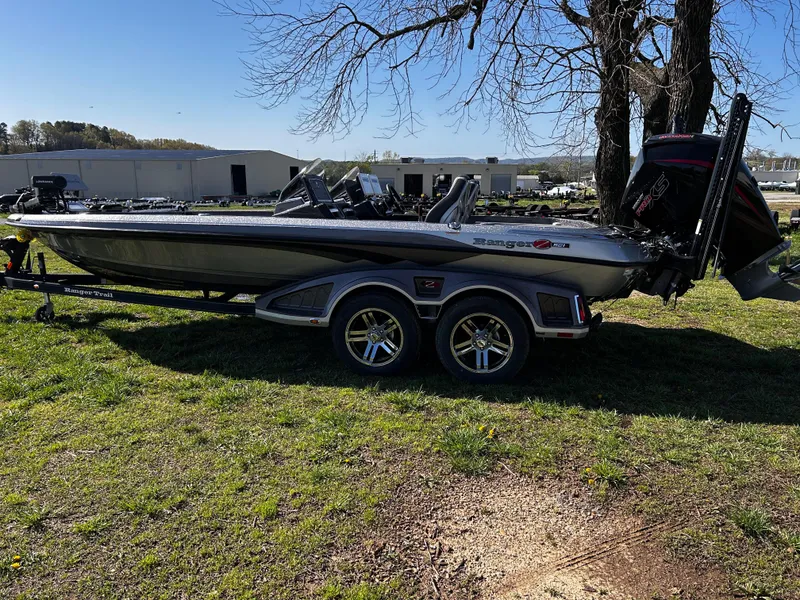 Slide: The Image of 2023 Ranger Z521R Ranger Cup Equipped boat on trailer, parked on grass. - 16