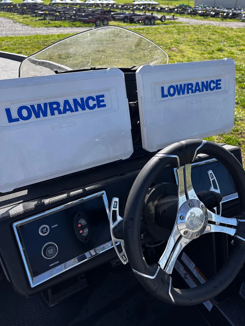 Slide: The Image of 2023 Ranger Z521R boat dashboard with dual Lowrance displays and steering wheel. - 22