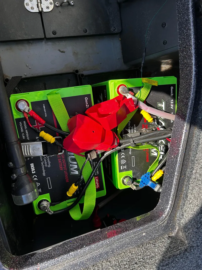 Slide: The Image of 2023 Ranger Z521R boat battery compartment with lithium batteries and wiring. - 29