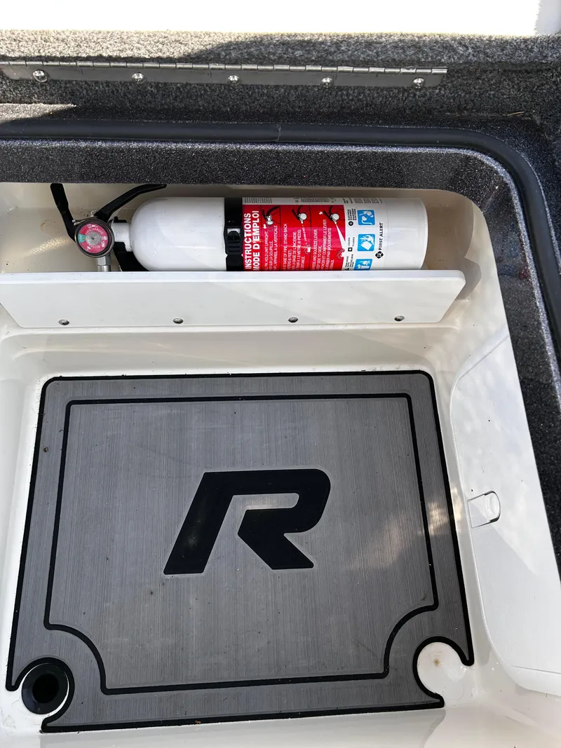 Slide: The Image of 2023 Ranger Z521R storage compartment with fire extinguisher and branded mat. - 30