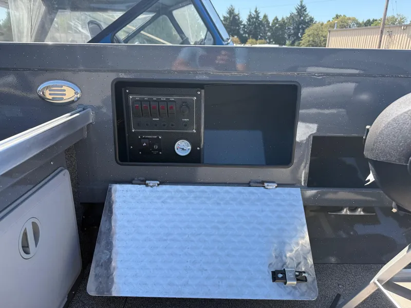 Slide: The Image of 2025 Fish Rite River Master 20 with Yamaha outboard motor in a parking lot. - 11