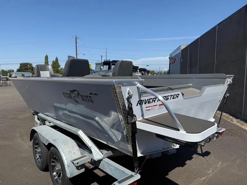 Slide: The Image of 2025 Fish Rite River Master 20 boat on trailer under clear blue sky. - 3