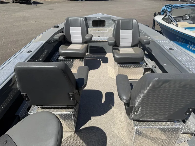 Slide: The Image of Open storage compartment on 2025 Fish Rite River Master 20 boat, featuring diamond plate design. - 6