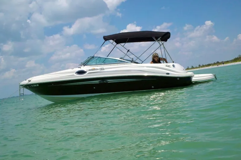 The Image of 2007 Sea Ray 240 Sundeck boat on calm water under a clear sky. - 0