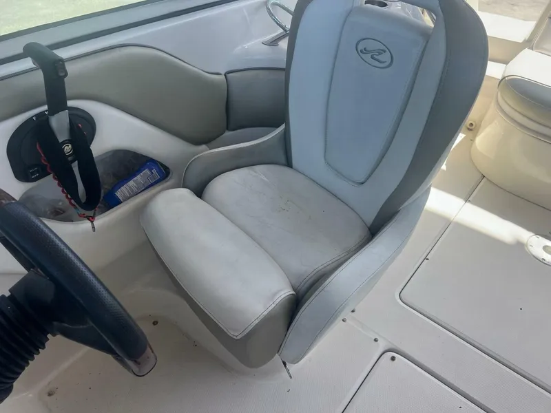 Slide: The Image of Interior of a 2007 Sea Ray 240 Sundeck boat, white seating. - 11