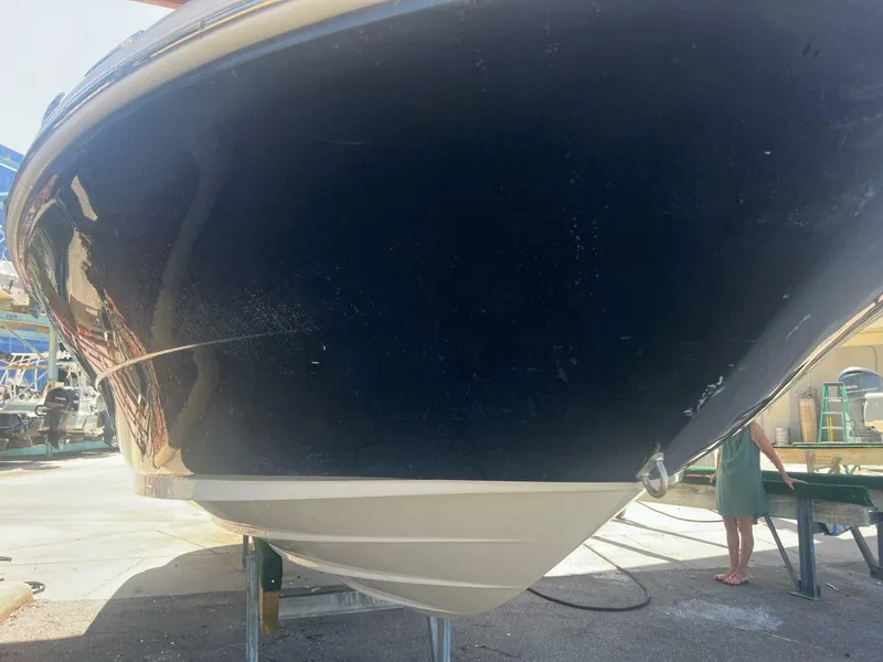 Slide: The Image of 2007 Sea Ray 240 Sundeck boat docked at marina, featuring sleek design and spacious seating. - 2