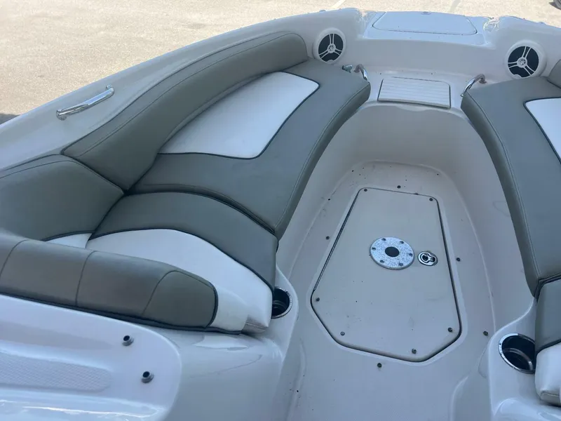 Slide: The Image of 2007 Sea Ray 240 Sundeck boat under a metal roof, viewed from the front. - 24