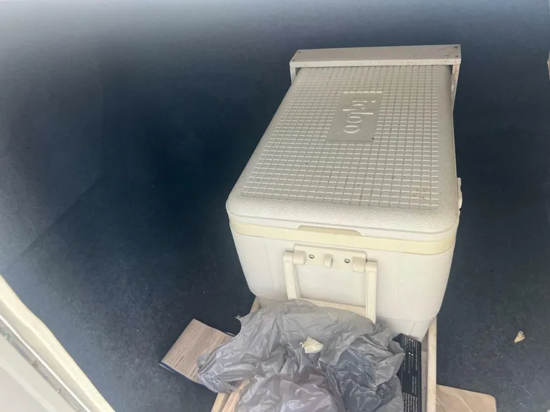 Slide: The Image of White Igloo cooler inside 2007 Sea Ray 240 Sundeck boat compartment. - 35