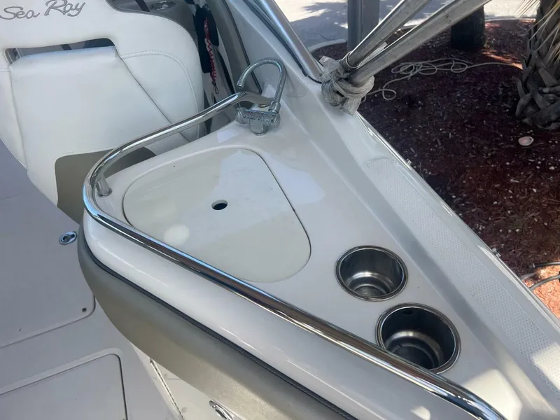Slide: The Image of 2007 Sea Ray 240 Sundeck boat hull on metal stand in marina. - 9