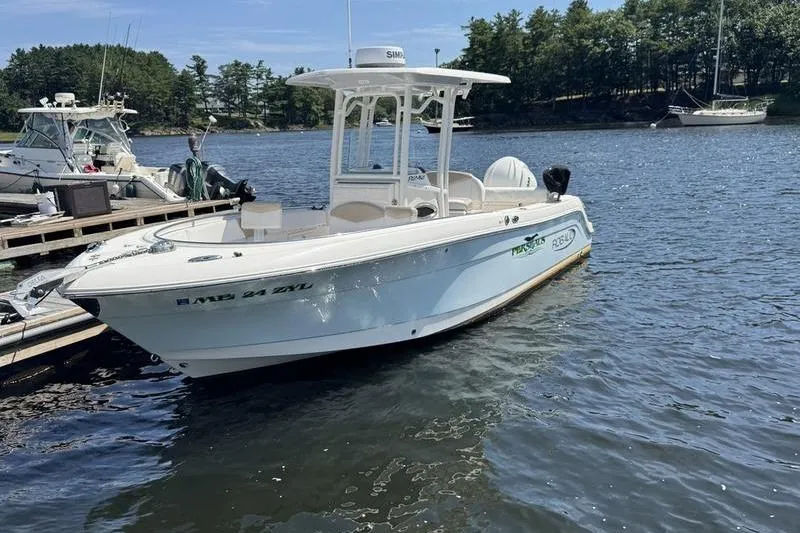 The Image of 2021 Robalo R242 Center Console boat docked on a sunny day. - 0