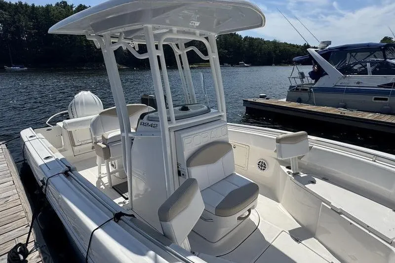 Slide: The Image of 2021 Robalo R242 Center Console boat docked by the water. - 4