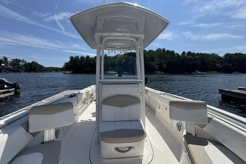 Slide: The Image of 2021 Robalo R242 Center Console boat on a lake with clear skies. - 6