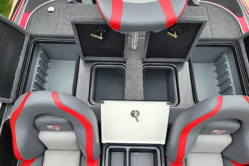 Slide: The Image of 2023 Triton 179 TrX boat interior with storage compartments and red-accented seats. - 6