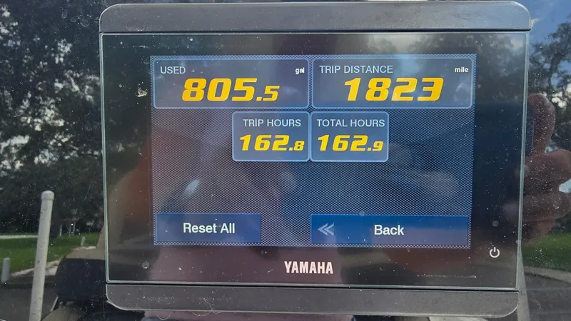 Slide: The Image of Display screen showing fuel usage, trip distance, and hours for a 2021 Tidewater 2410 Bay Max. - 13