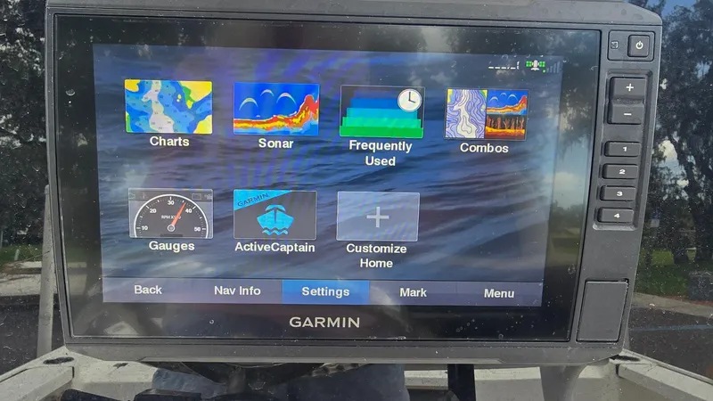 Slide: The Image of Garmin marine display showing navigation and sonar options on a 2021 Tidewater 2410 Bay Max. - 14