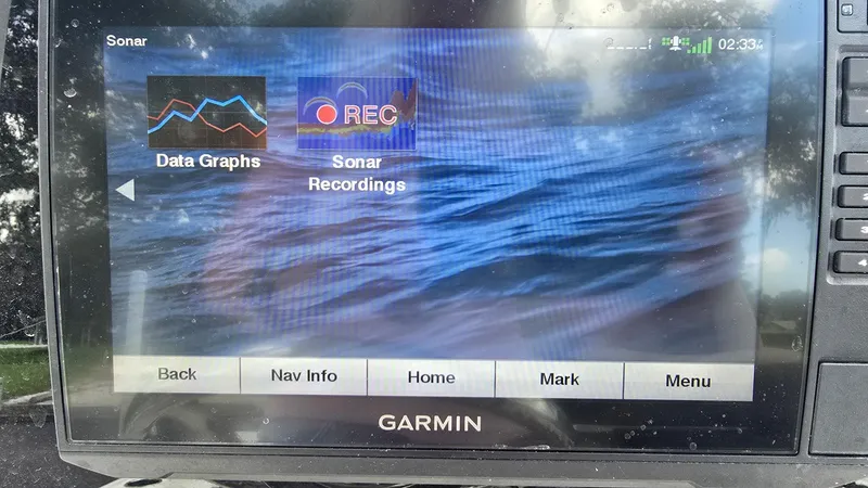 Slide: The Image of Garmin sonar display showing data graphs and sonar recordings on a Tidewater 2410 Bay Max. - 15