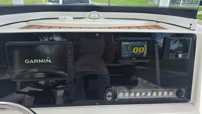 Slide: The Image of 2021 Tidewater 2410 Bay Max dashboard with Garmin and Yamaha displays. - 17