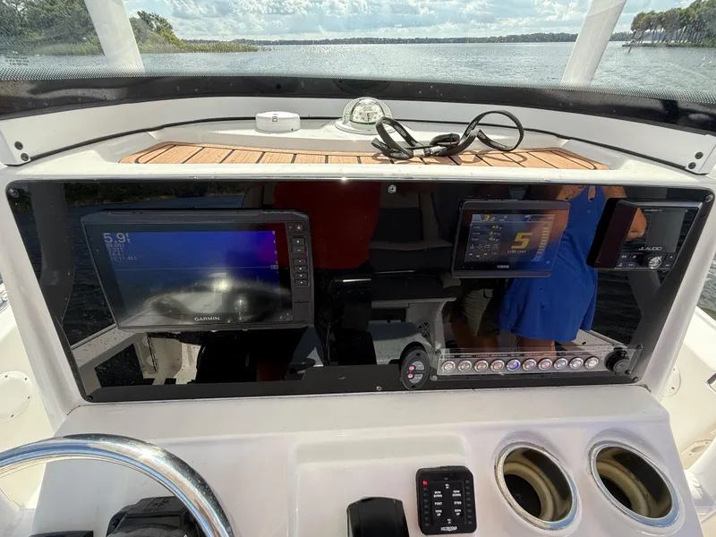 Slide: The Image of 2021 Tidewater 2410 Bay Max boat dashboard with Garmin and Yamaha displays. - 18