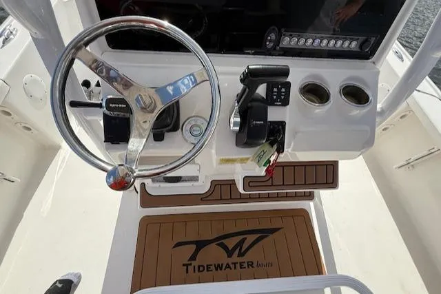 Slide: The Image of 2021 Tidewater 2410 Bay Max boat console with steering wheel and controls. - 19