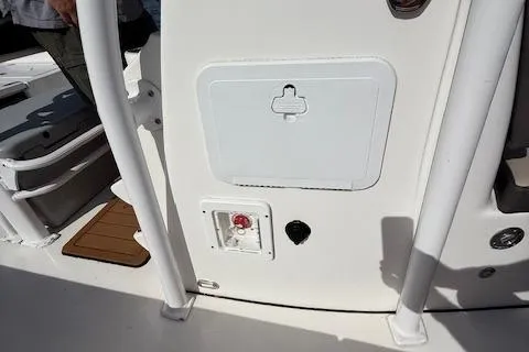 Slide: The Image of 2021 Tidewater 2410 Bay Max boat interior with storage compartment and control panel. - 23