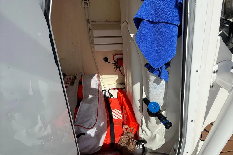 Slide: The Image of Storage compartment of a 2021 Tidewater 2410 Bay Max boat with gear and accessories. - 27