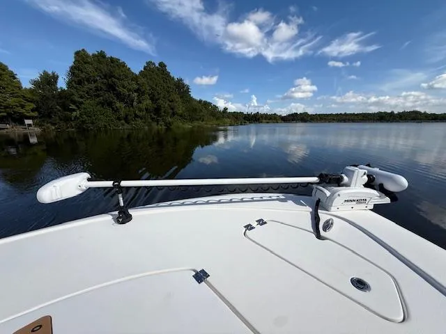Slide: The Image of 2021 Tidewater 2410 Bay Max boat on calm lake with clear sky and trees. - 30