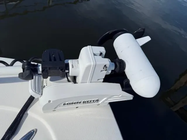Slide: The Image of Minn Kota trolling motor on 2021 Tidewater 2410 Bay Max boat, docked on calm water. - 32