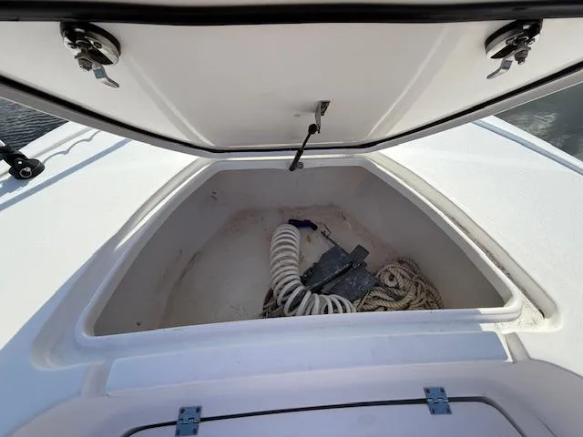 Slide: The Image of Open storage compartment on 2021 Tidewater 2410 Bay Max boat with rope and anchor. - 34
