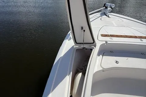 Slide: The Image of 2021 Tidewater 2410 Bay Max boat with open storage compartment on calm water. - 36