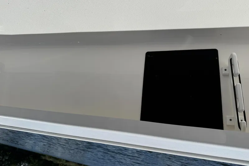 Slide: The Image of 2021 Tidewater 2410 Bay Max boat storage compartment with hatch and handle. - 39