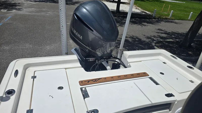Slide: The Image of 2021 Tidewater 2410 Bay Max boat with Yamaha outboard motor, docked in a sunny parking area. - 43