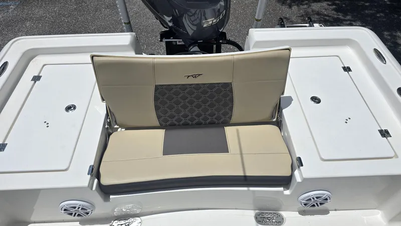 Slide: The Image of 2021 Tidewater 2410 Bay Max boat seating area with beige and gray upholstery. - 44
