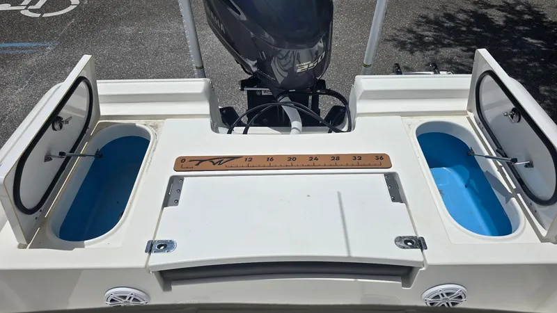 Slide: The Image of 2021 Tidewater 2410 Bay Max boat with open storage compartments and Yamaha 250 engine. - 46