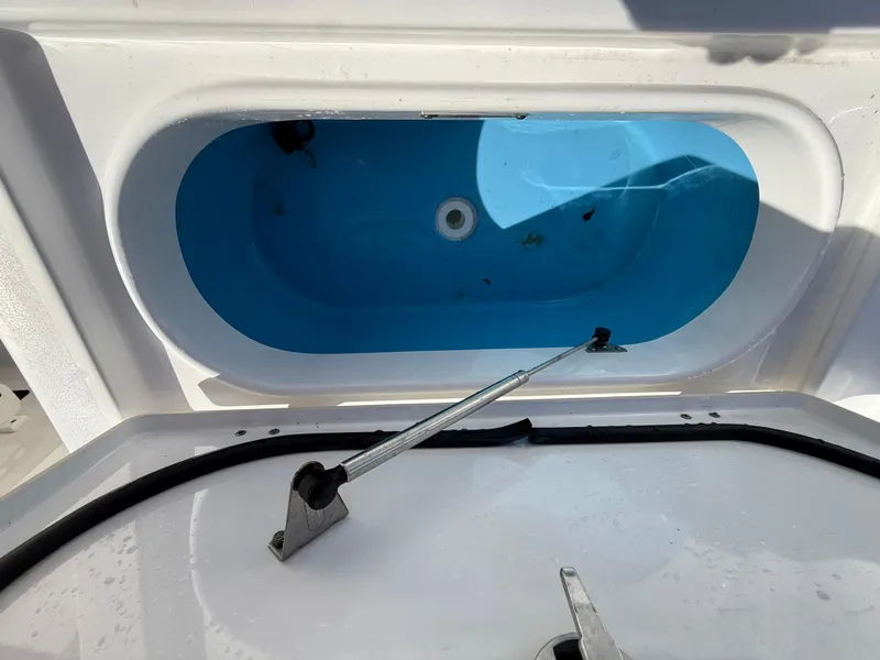 Slide: The Image of Livewell compartment of 2021 Tidewater 2410 Bay Max boat, open and empty. - 50