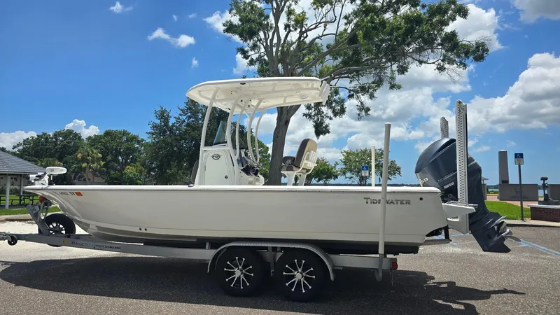 Slide: The Image of 2021 Tidewater 2410 Bay Max boat on trailer, parked outdoors under a sunny sky. - 54