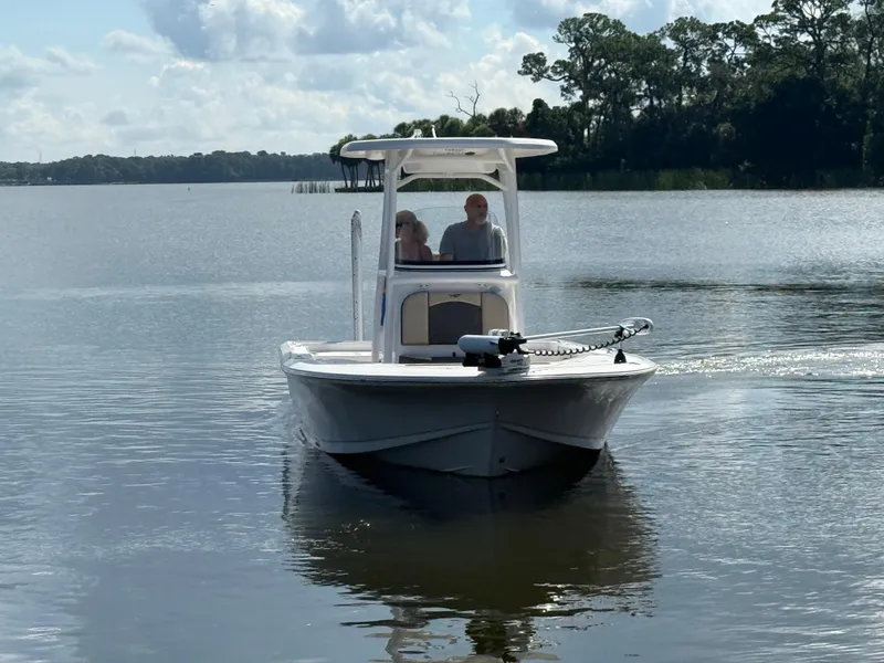 Slide: The Image of 2021 Tidewater 2410 Bay Max boat cruising on a calm lake under a cloudy sky. - 9