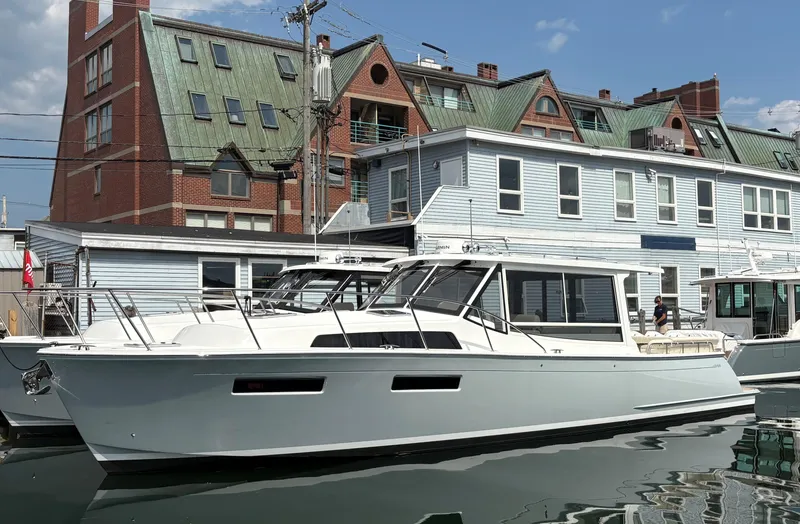 Slide: The Image of 2026 MJM 47R yacht docked near buildings under a clear sky. - 2