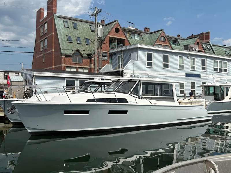 Slide: The Image of 2026 MJM 47R yacht docked at marina, modern design, clear sky background. - 3