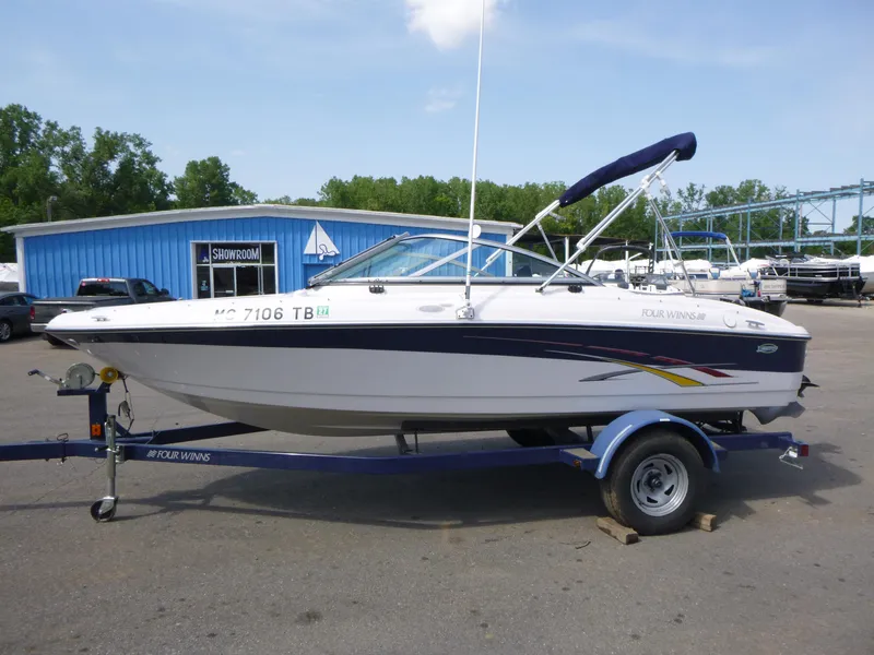 Slide: The Image of 2007 Four Winns 180 Horizon boat on trailer, parked near blue showroom building. - 4