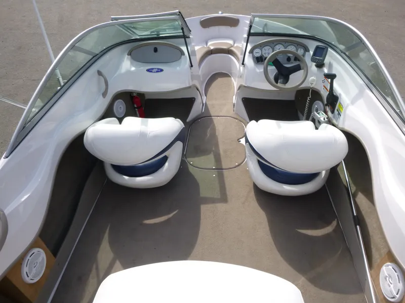 Slide: The Image of 2007 Four Winns 180 Horizon boat interior with white seating and dashboard controls. - 5
