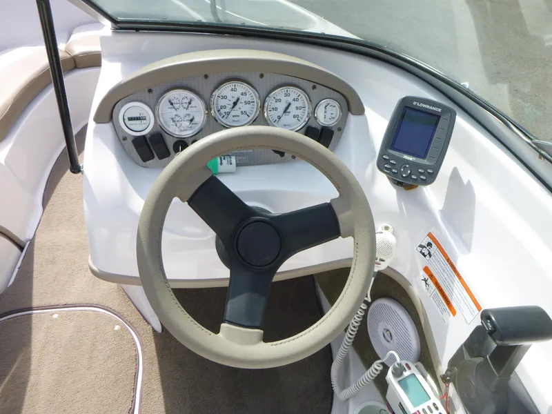 Slide: The Image of 2007 Four Winns 180 Horizon boat dashboard with steering wheel and gauges. - 8