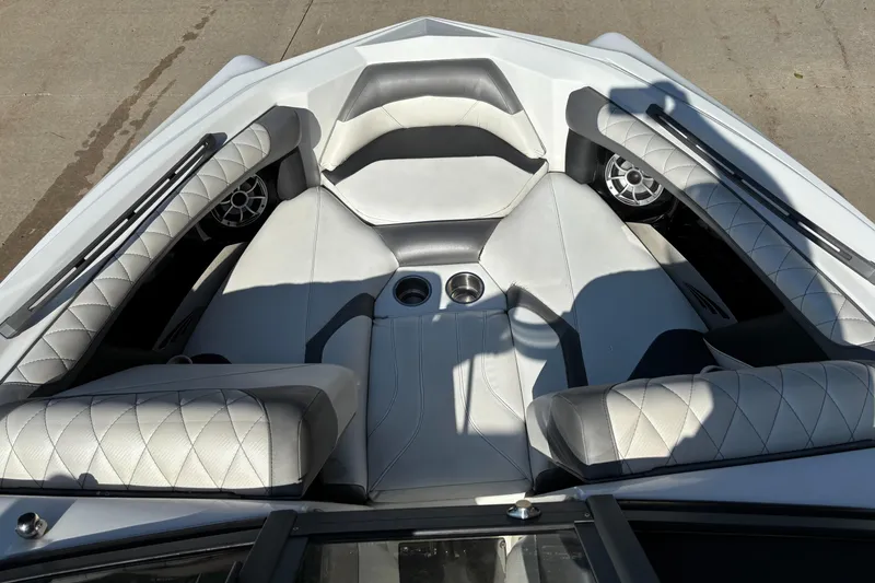 Slide: The Image of 2014 Tigé RZR boat interior with white quilted seats and cup holders. - 4