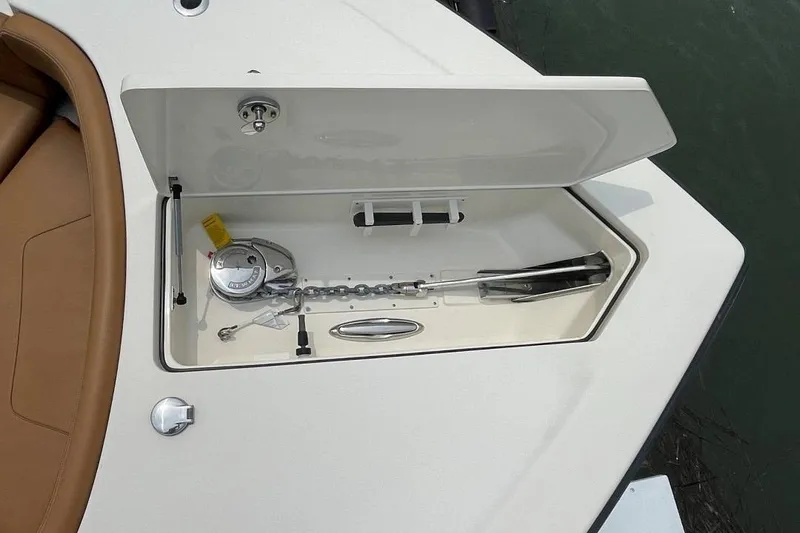 Slide: The Image of 2020 Scout 420 LXF anchor compartment with open hatch, showcasing anchor and chain storage. - 13